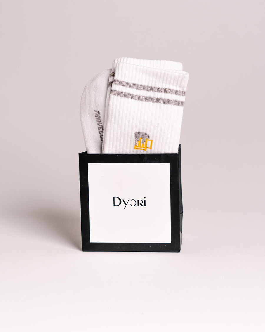 White socks with gray stripes in a black box featuring the 'Dyori' brand on a light gray background. Secret Santa Gifts