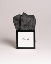Gray socks with bicycle pattern in a black Dyori box on a light gray background. Secret Santa Gifts Malta