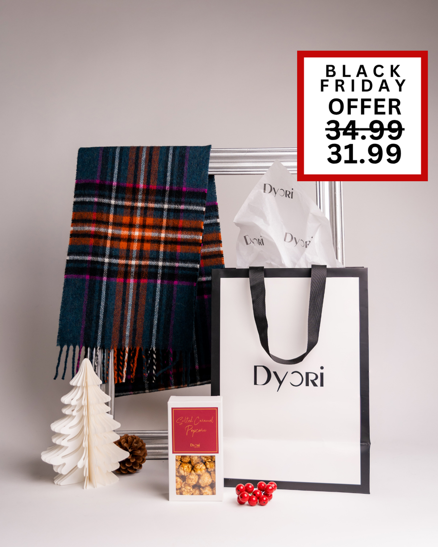 Stylish Black Friday Dyori Christmas gift set with a multicolored plaid scarf, festive salted caramel popcorn, and elegant branded gift bag. A warm and thoughtful luxury present idea for anyone in Malta this holiday season.