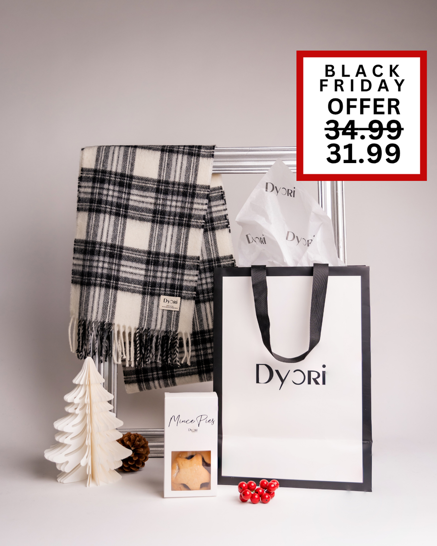 A sophisticated Dyori gift set featuring a black and white plaid scarf, mince pies, and gift bag. A modern festive present for the Christmas season in Malta.