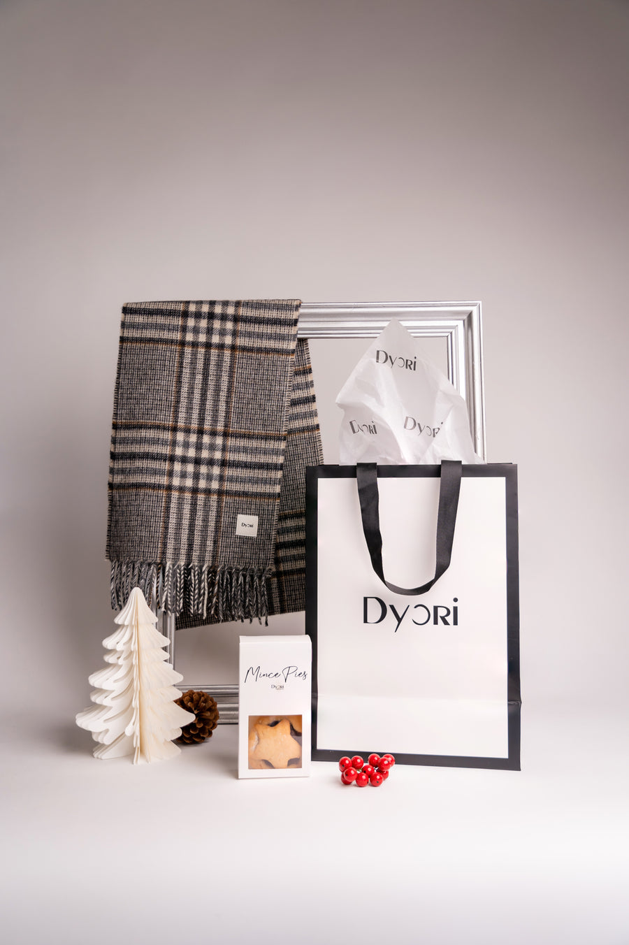 Dyori’s brown and grey plaid merino wool scarf delivers refined comfort and charm for the Christmas season.