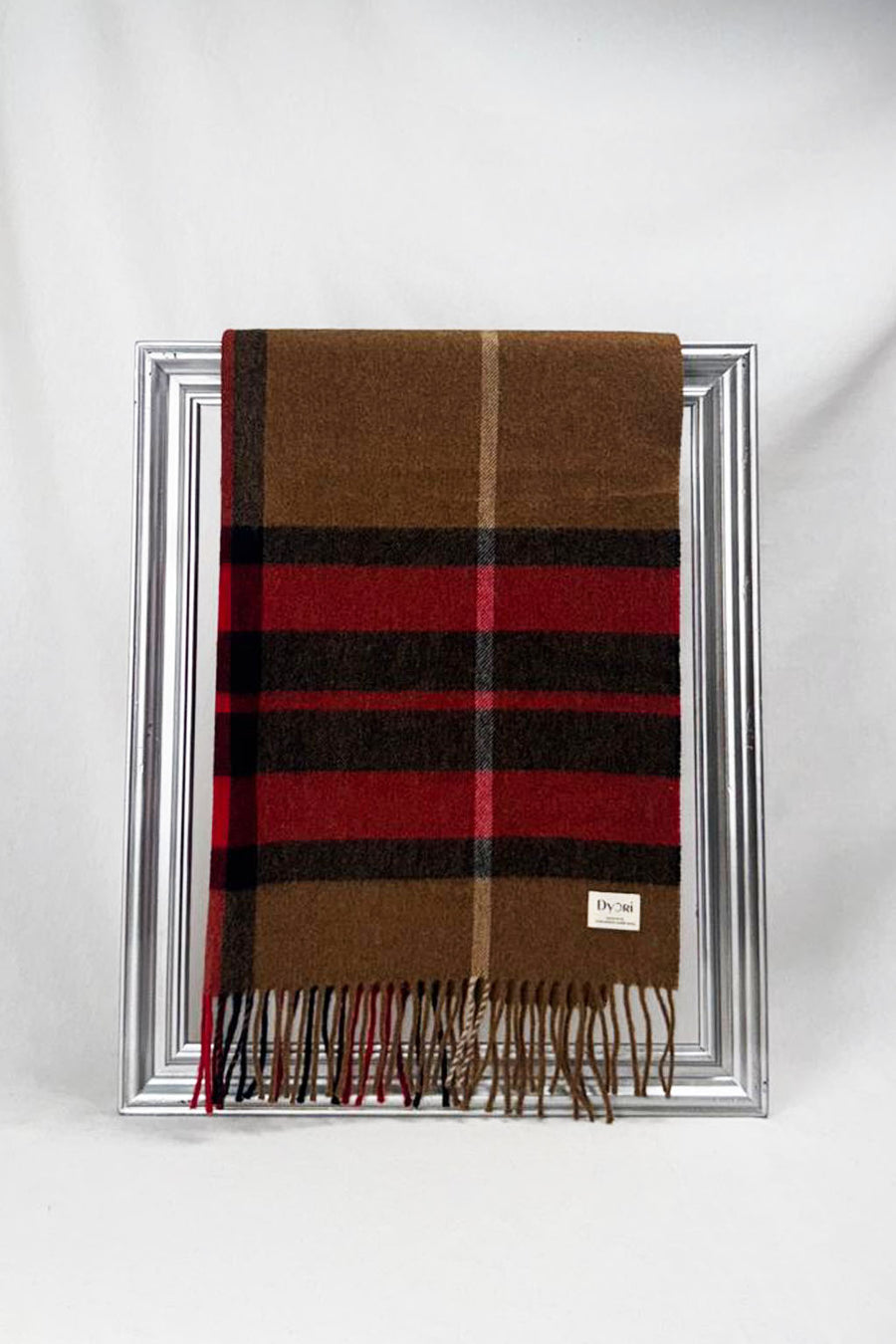 Luxurious Witney merino wool scarf featuring warm tones of brown, red, and black checks. Soft, cozy, and perfect for adding style and warmth to any outfit.