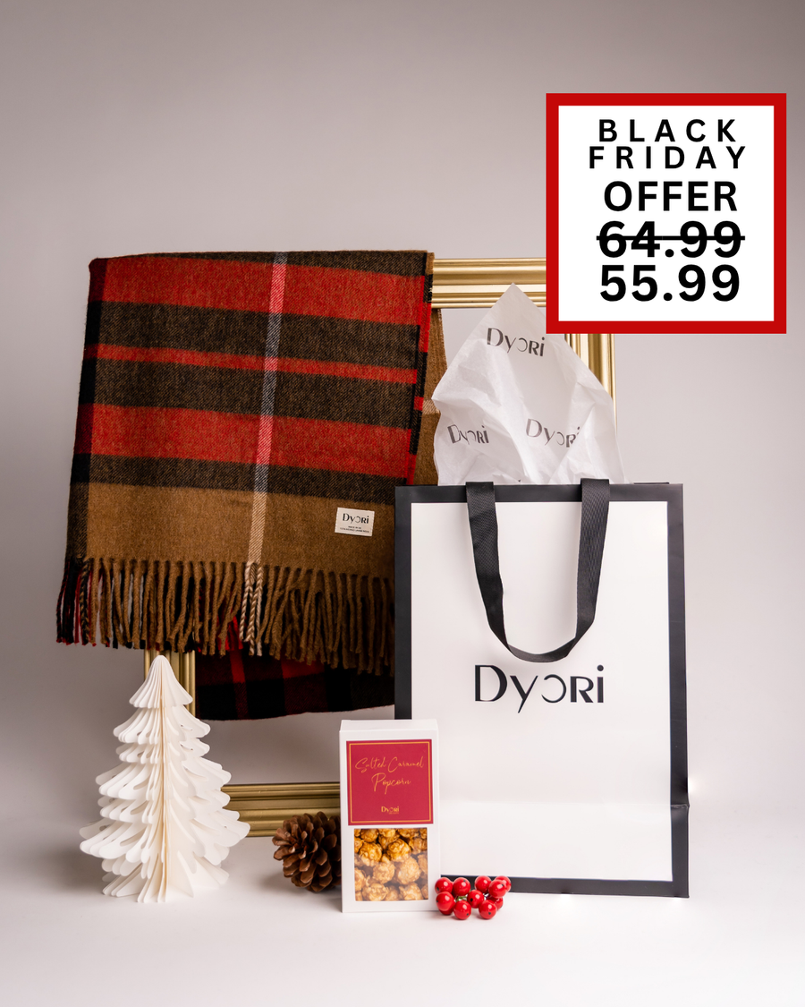 A Dyori Christmas gift featuring a brown and red checked scarf, popcorn, and branded packaging. A cozy and classic gift idea for Malta’s festive season.