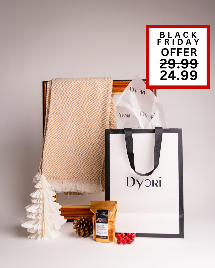 A cozy Dyori Christmas set with a soft cream scarf, truffles, and branded packaging. A refined and elegant holiday gift perfect for delivery across Malta.