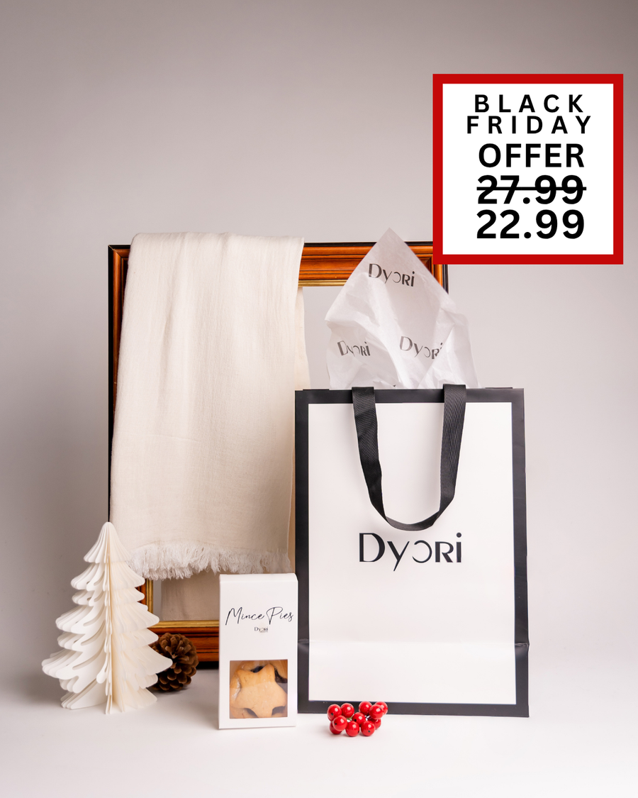 A soft cream Dyori scarf paired with festive mince pies and a luxury bag. A simple yet elegant Christmas gift option available during Black Friday in Malta.
