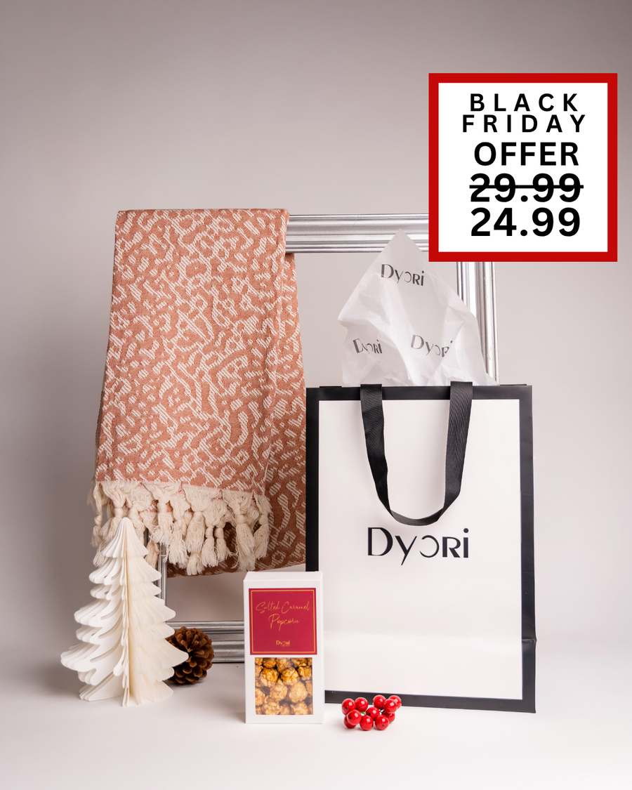 Warm and earthy terracotta throw blanket paired with gourmet salted caramel popcorn and an elegant Dyori bag. A thoughtful and unique Christmas gift that captures festive charm, available for delivery across Malta.