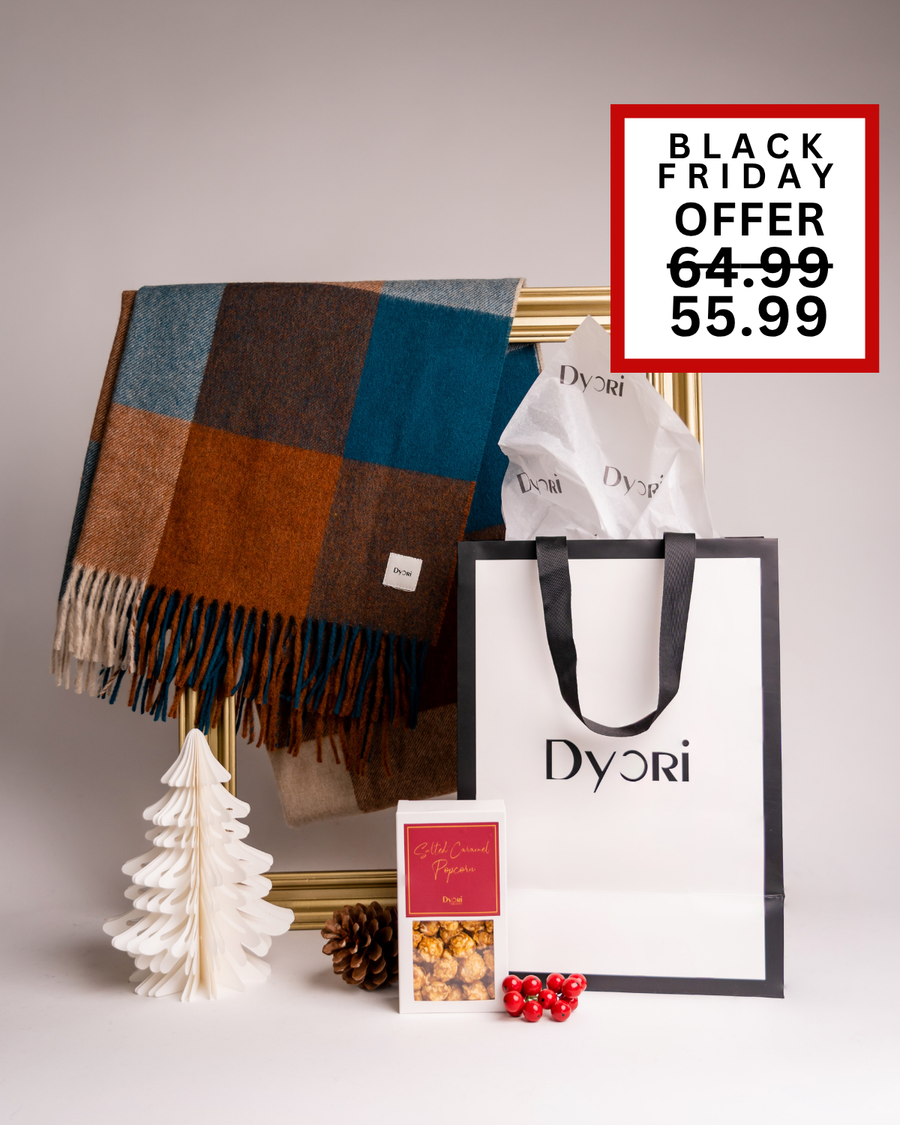 A vibrant Dyori holiday gift set with a blue and orange plaid scarf, popcorn, and gift bag. A colorful and modern Christmas present available for delivery across Malta.