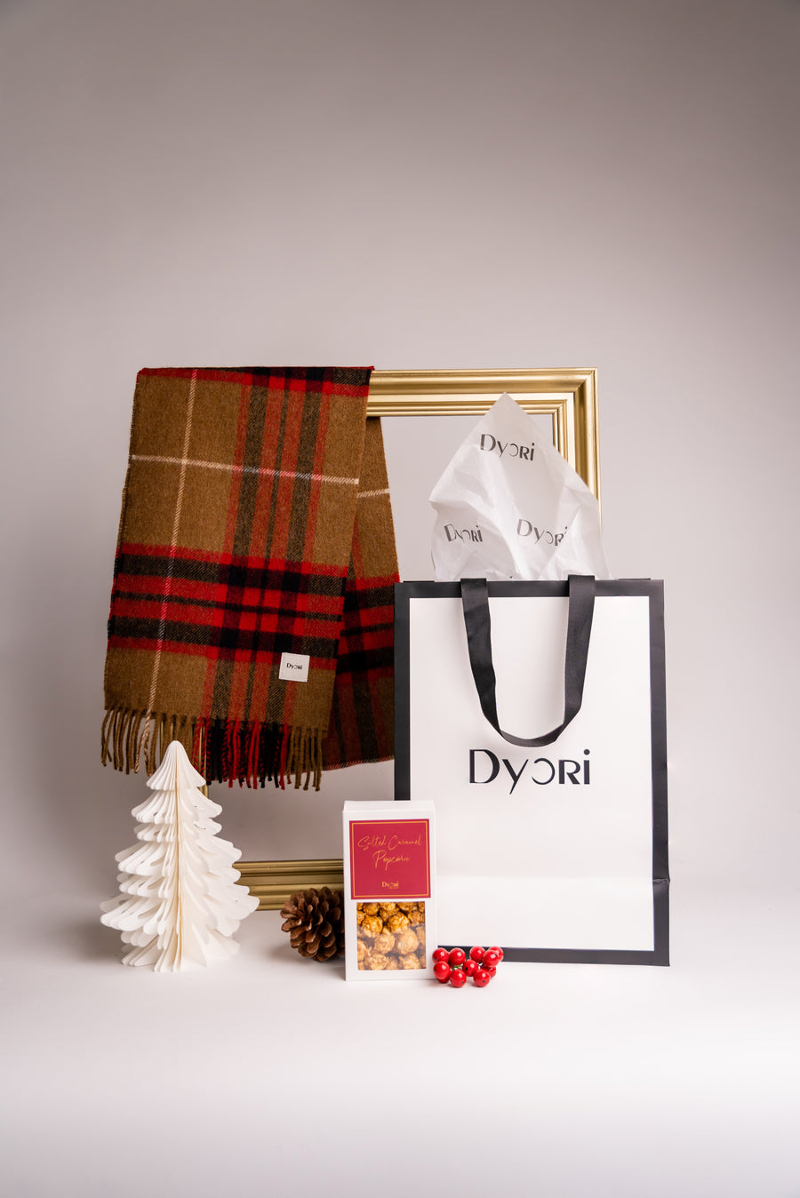 Add festive charm with Dyori’s brown and red plaid merino wool scarf, crafted for warmth and luxury this Christmas.