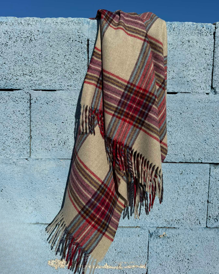 Premium beige merino wool scarf with red and blue check design. Lightweight, stylish, and warm — the perfect accessory to elevate your winter wardrobe.
