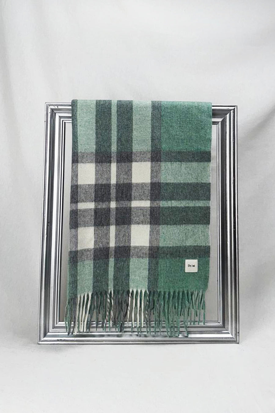 Stylish merino wool scarf featuring a classic green and grey check design with soft fringes. High-quality craftsmanship and timeless appeal make it an ideal unisex gift for any occasion. Perfect for cozy comfort and delivered across Malta.