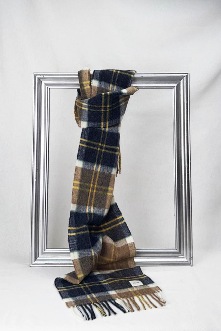 Premium merino wool scarf featuring a sophisticated navy, camel, and mustard check design with delicate fringes. Warm, timeless, and perfect as a thoughtful gift for men or women in Malta.