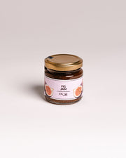 Jar of fig jam with a gold lid on a light gray background. Corporate orders Malta