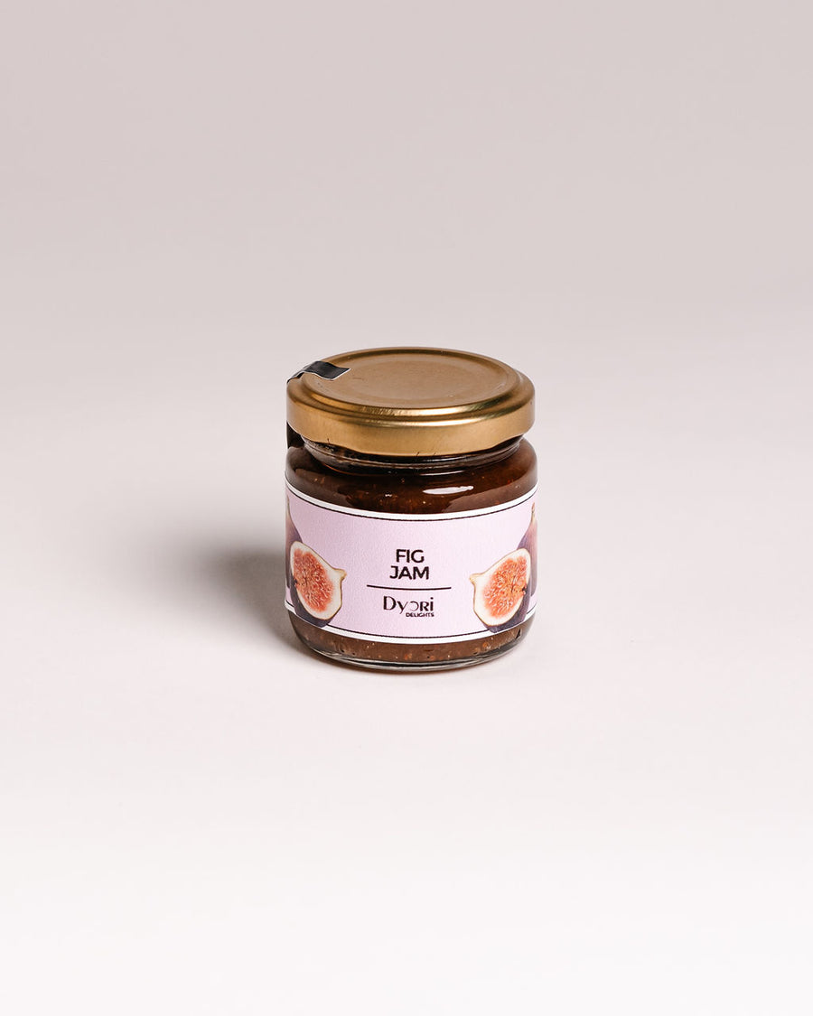 Jar of fig jam with a gold lid on a light gray background. Corporate orders Malta
