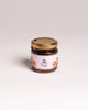 Jar of fig jam with a gold lid on a light gray background. Corporate orders Malta