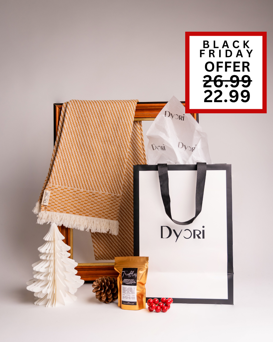 A golden-toned Dyori scarf paired with chocolate truffles and elegant packaging. A beautiful Christmas or corporate gift option in Malta during the Black Friday sale.