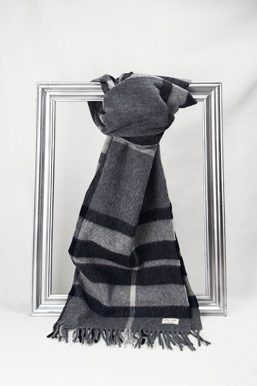 Luxurious grey and charcoal check merino wool scarf with soft fringes. Designed for warmth and timeless style — an ideal gift for men or women. Available in Malta.