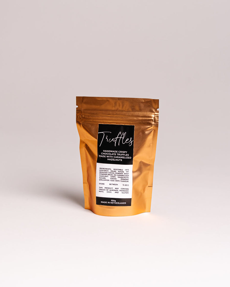 Brown packaging of truffles with a label on a light gray background. Gourmet Gifts Malta