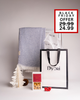 Beautifully presented Dyori Christmas gift with a blue woven throw, salted caramel popcorn, and sleek black-and-white packaging. A stylish and practical luxury gift idea for this Black Friday in Malta.