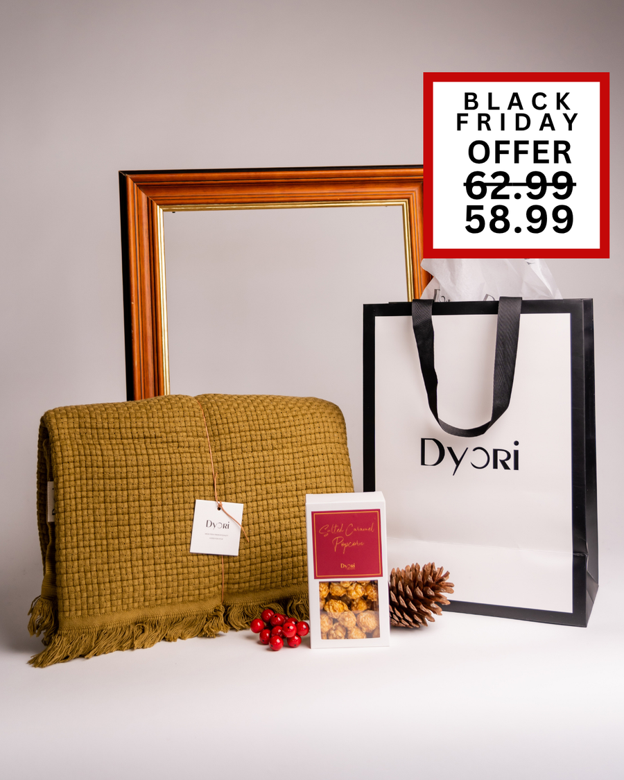 A cozy olive green textured throw styled with gourmet popcorn and elegant packaging — a sophisticated Christmas hamper idea from Dyori, perfect for him or her. Delivered across Malta.