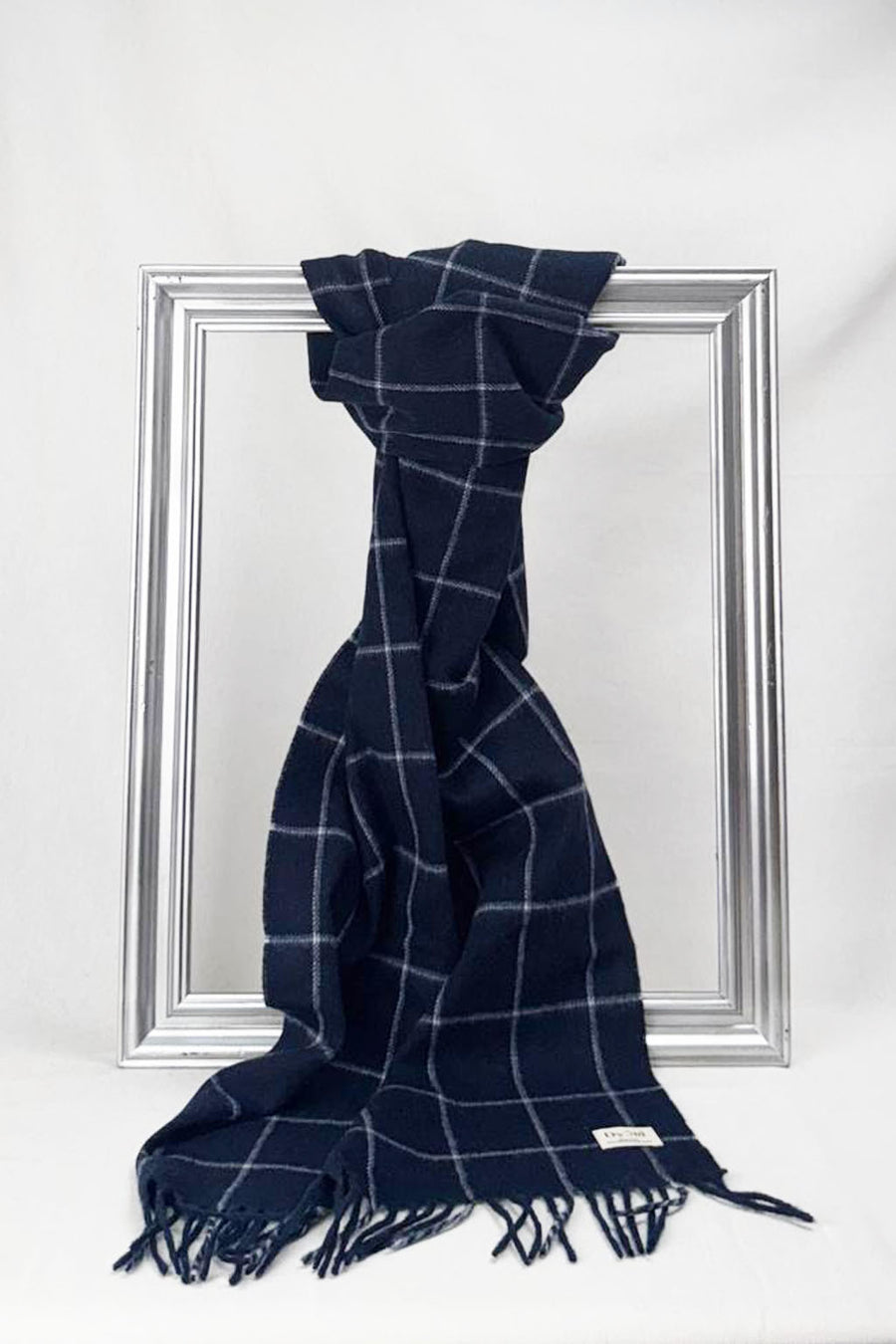 Classic navy merino wool scarf featuring a subtle windowpane pattern and fine fringe detailing. Premium quality and versatile style make it an ideal unisex gift for any season. Available for delivery in Malta.