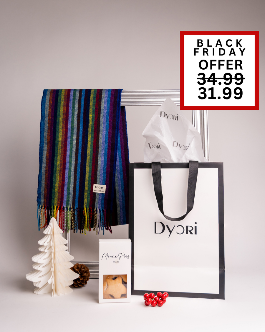 A bright and colorful Dyori scarf with a striped design, paired with mince pies and festive packaging. A fun and lively Christmas gift idea in Malta.