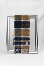 Stylish merino wool scarf in a rich navy, camel, and mustard check pattern, elegantly draped over a silver frame. Luxuriously soft and warm — the perfect unisex gift for him or her. Delivered in Malta.