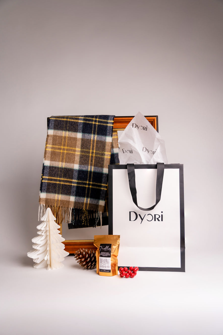 Wrap up in sophistication with Dyori’s navy and mustard merino wool scarf, styled for holiday gifting.