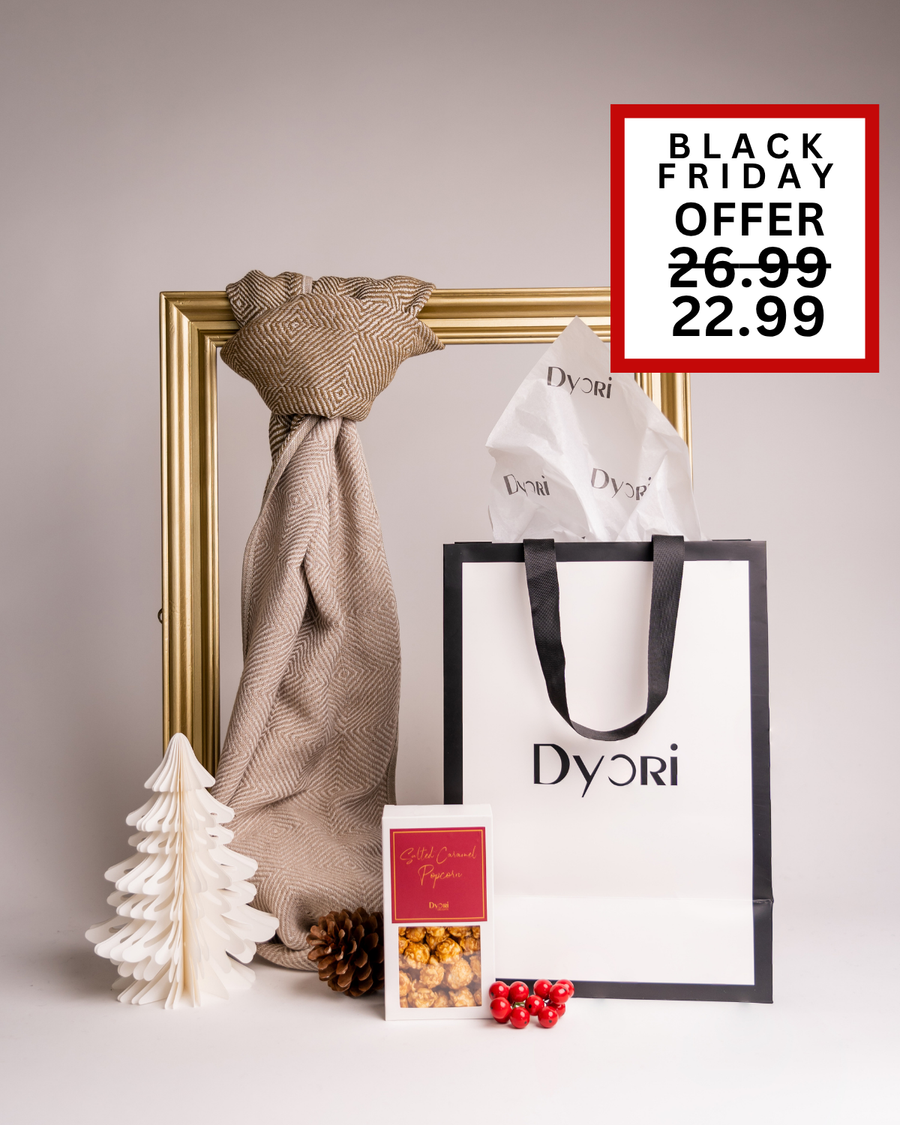 A soft neutral-toned Dyori gift set with a beige scarf, popcorn, and gift bag. A stylish and understated Christmas gift for anyone in Malta.