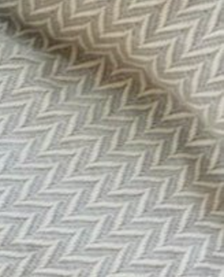 Dyori Pebble Grey Herringbone Turkish Cotton Throw – 100% cotton blanket in soft grey and cream chevron pattern, handwoven in Turkey for a sophisticated and cozy touch.