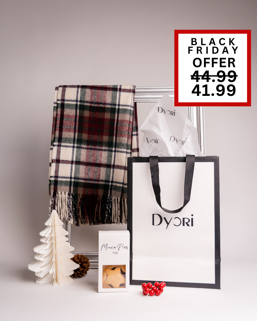 A cozy tartan Dyori scarf in red and green, paired with mince pies and elegant packaging. A traditional and heartwarming Christmas gift for anyone in Malta.